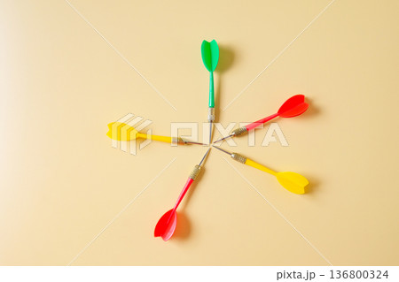 Colorful plastic darts arrow on color background. Colorful plastic darts arrow on color background. 136800324