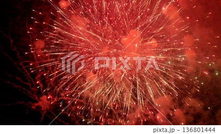 scarlet fireworks brighten midnight sky scene, dynamic crimson pyrotechnics illuminate evening with smoky radiance, lively night explosion of red fireworks casting glowing halos across darkened sky scarlet fireworks brighten midnight sky scene, dynamic crimson pyrotechnics illuminate evening with smoky radiance, lively night explosion of red fireworks casting glowing halos across darkened sky 136801444