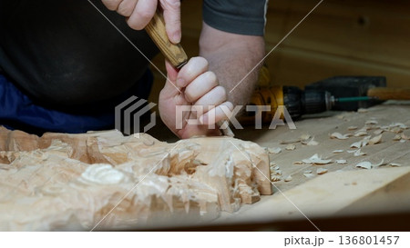Woodcraft with tools, Skilled artisan carving wood amidst modern and traditional instruments, Hand sculptor engaged in detailed woodworking using range of vintage and contemporary tools 136801457