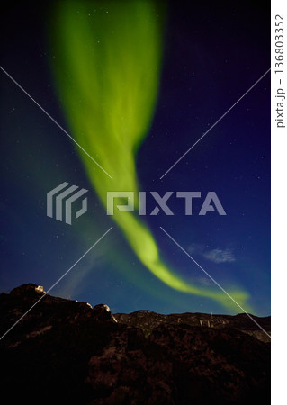 Aurora borealis over ocean in Teriberka, Russia, Murmansk region, Northern lights, Starry sky with polar lights and clouds. Night autumn landscape with bright aurora, stars, sea Aurora borealis over ocean in Teriberka, Russia, Murmansk region, Northern lights, Starry sky with polar lights and clouds. Night autumn landscape with bright aurora, stars, sea 136803352