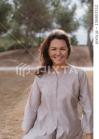 Smiling Woman Enjoying Outdoor Scenery in Nature Smiling Woman Enjoying Outdoor Scenery in Nature 136803512