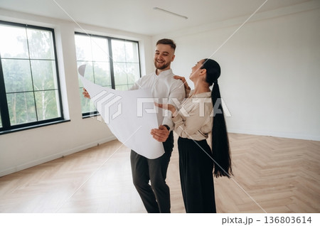 Guidance by the plan. Man and woman are in the modern new room, conception of business 136803614