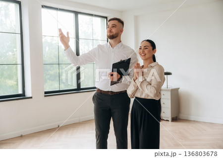 Man and woman are in the modern new room, conception of business 136803678