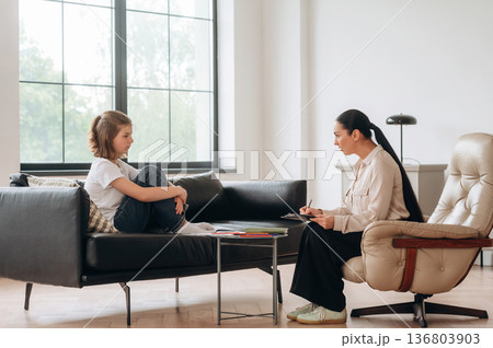 Process of therapy session. Girl at a psychologist's appointment Process of therapy session. Girl at a psychologist's appointment 136803903