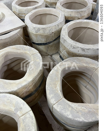 Clay vessels are arranged and prepared for pottery making in a vibrant ceramic workshop, showcasing artistic techniques and craftsmanship Clay vessels are arranged and prepared for pottery making in a vibrant ceramic workshop, showcasing artistic techniques and craftsmanship 136804093