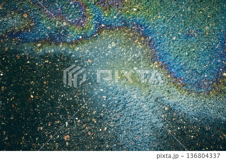 Iridescent oil slick on asphalt, creating a dynamic abstract composition 136804337