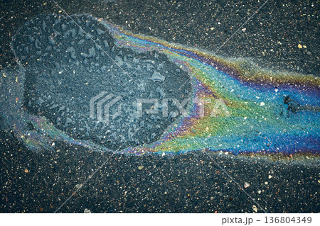 Oil Spill on Pavement Creates Colorful Pattern During Daytime in Urban Area Oil Spill on Pavement Creates Colorful Pattern During Daytime in Urban Area 136804349
