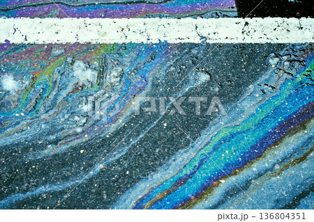 Gasoline rainbow spill creating iridescent oil slick texture. Gasoline rainbow spill creating iridescent oil slick texture. 136804351