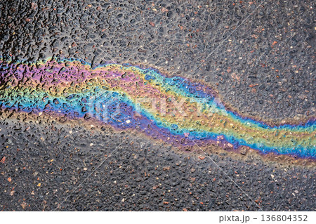 Fuel spill creating vibrant rainbow colors on a wet asphalt road surface Fuel spill creating vibrant rainbow colors on a wet asphalt road surface 136804352
