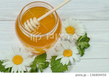 fresh honey in a jar on a wooden background with daisies, banner, advertising 136804450