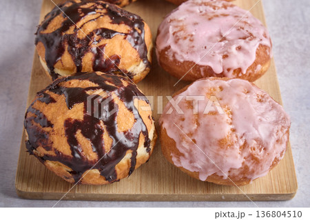 Chocolate and Pink Glazed Donuts on Board 136804510