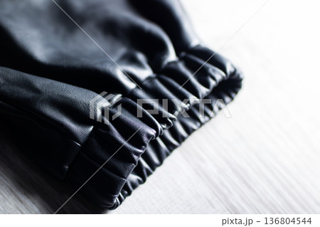 Close examination of polished leather cuff showcasing intricate stitching design 136804544