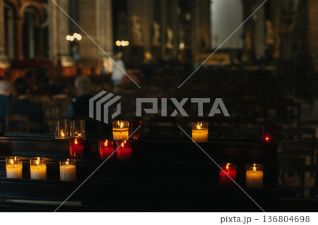 Burning candles in an old church. 136804698