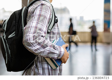 Student with books in hall Student with books in hall 136804723