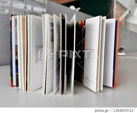 an open book standing on a table on a light background an open book standing on a table on a light background 136805012