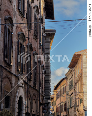 Sundrenched Alleyway Lined With Aged Brick Facades And Shutters Sundrenched Alleyway Lined With Aged Brick Facades And Shutters 136805024