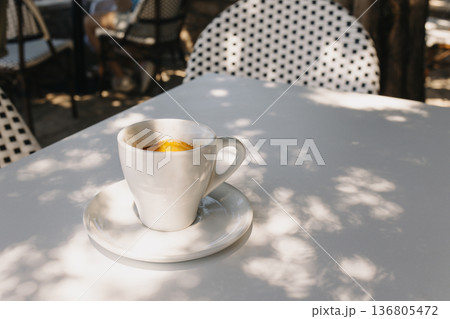 Cup of black coffee on a table in a street cafe. Cup of black coffee on a table in a street cafe. 136805472