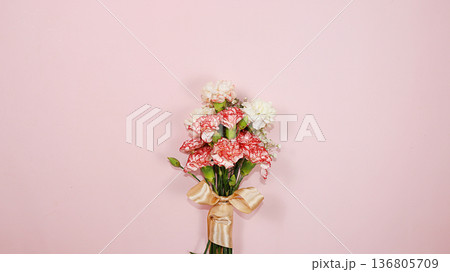 Carnations on a pink table, abstract spring floral background. Creative modern bouquet, minimal holiday concept. Greeting card for Women's Day or Mother's Day, happy birthday, wedding, gift for loved Carnations on a pink table, abstract spring floral background. Creative modern bouquet, minimal holiday concept. Greeting card for Women's Day or Mother's Day, happy birthday, wedding, gift for loved 136805709