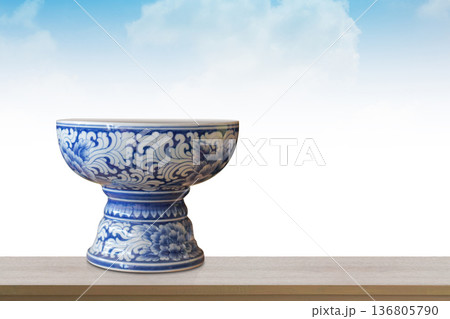 front view beautiful white and blue ceramic phan on brown wooden floor, blue sky and white cloud background, object, decor, fashion, antique, nature, copy space front view beautiful white and blue ceramic phan on brown wooden floor, blue sky and white cloud background, object, decor, fashion, antique, nature, copy space 136805790