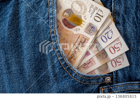Jeans with british pound money. United Kindom bills in the pants pocket for commerce concept. Jeans with british pound money. United Kindom bills in the pants pocket for commerce concept. 136805815