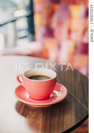 Cup of black coffee on a table in a cafe. Selective focus. Cup of black coffee on a table in a cafe. Selective focus. 136805834