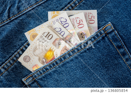Jeans with british pound money. United Kindom bills in the pants pocket for commerce concept. 136805854