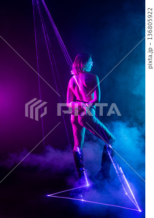 Futuristic cyberpunk woman in neon laser light show 136805922