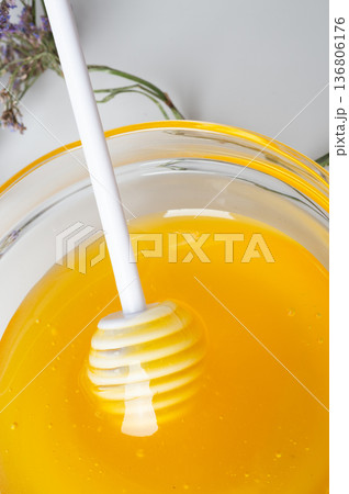 linden fresh honey with spoon on white table with herb. top view linden fresh honey with spoon on white table with herb. top view 136806176