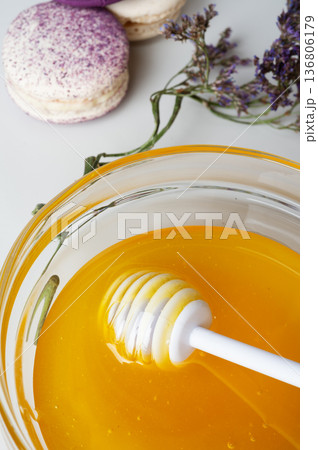 linden fresh honey with spoon and macaroons on white.  macro.  top view 136806179