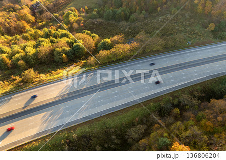 Elevated view of freeway road lanes with fast moving traffic cars and trucks. Interstate transportation infrastructure in USA Elevated view of freeway road lanes with fast moving traffic cars and trucks. Interstate transportation infrastructure in USA 136806204