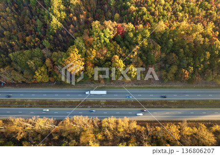 Wide multilane highway road in USA Appalachian mountains with fast driving semi trucks. Above view of American transportation infrastructure Wide multilane highway road in USA Appalachian mountains with fast driving semi trucks. Above view of American transportation infrastructure 136806207