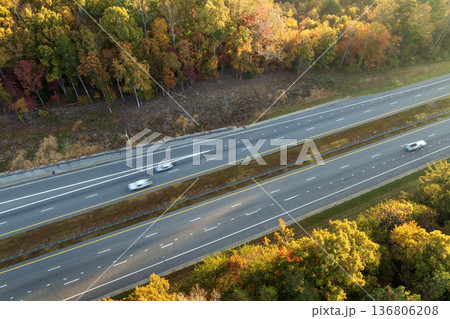 Freeway road with fast moving traffic cars and trucks in North Carolina Appalachian mountains in fall season. Interstate transportation infrastructure in USA Freeway road with fast moving traffic cars and trucks in North Carolina Appalachian mountains in fall season. Interstate transportation infrastructure in USA 136806208