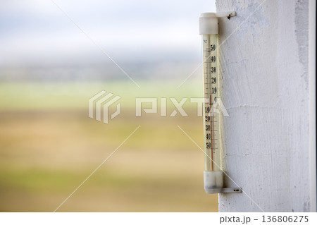 Alcohol glass thermometer Celsius outside on bright blurred light outdoors copy space background. Alcohol glass thermometer Celsius outside on bright blurred light outdoors copy space background. 136806275