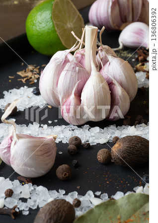 seasonings background with garlic and Spices served at black. Colorful natural meal additives. healthy food concept. close up seasonings background with garlic and Spices served at black. Colorful natural meal additives. healthy food concept. close up 136806392