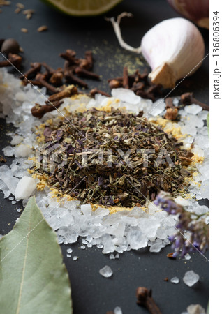 seasonings background with salt, Spices and garlic served  at black. Colorful natural meal additives. healthy food concept.  macro shot 136806394