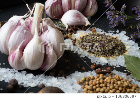 seasonings background with salt, Spices and garlic served  at black. Colorful natural meal additives. healthy food concept.  macro shot 136806397