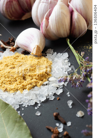 seasonings background with salt, Spices and garlic served  at black. Colorful natural meal additives. healthy food concept.  macro shot 136806404