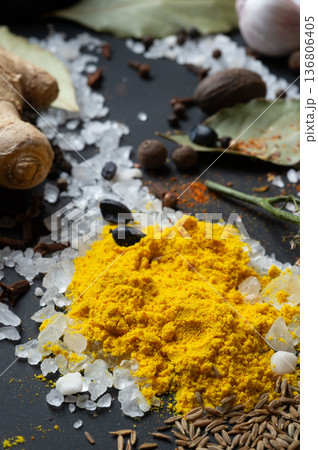 seasonings background with salt, Spices and garlic served  at black. Colorful natural meal additives. healthy food concept.  macro shot 136806405
