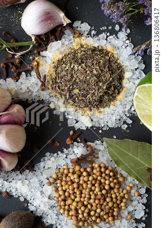 seasonings background with salt, Spices  and garlic served  at black. natural meal additives. healthy food concept. macro shot 136806417