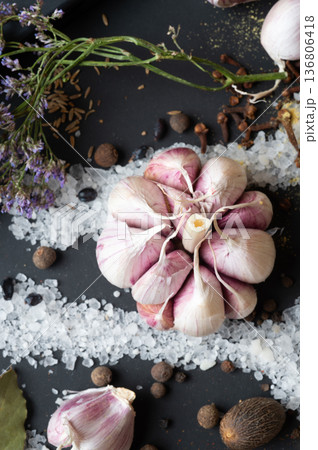 seasonings background with salt, Spices and garlic served at black. healthy food concept. top view macro shot seasonings background with salt, Spices and garlic served at black. healthy food concept. top view macro shot 136806418