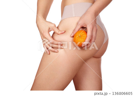 Body Care, Woman Health, Pinching Cellulite Holding Orange. Wellness Campaign, Nutritionist Role. Skin Dimpling, Firmness And Texture Differences. Wellness, Message Cellulite Contrast Through Citrus 136806605