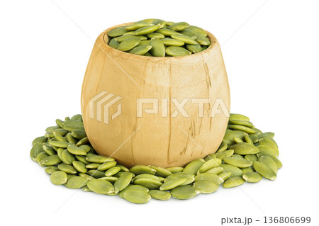 Peeled pumpkin seeds in wooden bowl isolated on white background Peeled pumpkin seeds in wooden bowl isolated on white background 136806699