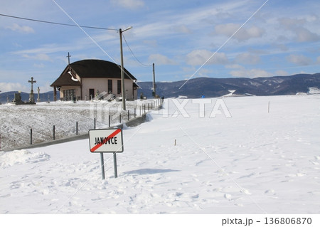 A village road is buried under a mountain of snow after a snowstorm. 136806870