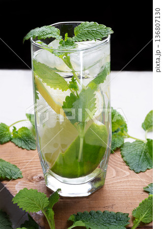 fresh lemonade served  in glass with  melissa and   ice . close up studio shot 136807130