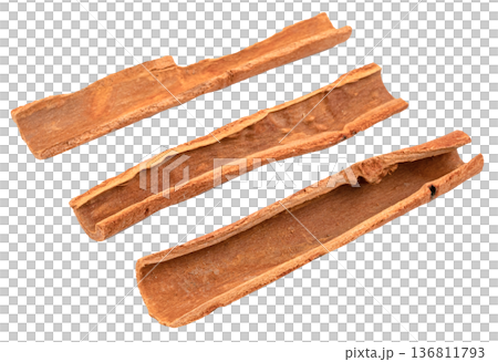 Three dried cinnamon bark sticks isolated. High quality aromatic spice for cooking, baking, and health. Close up view of natural cassia cinnamon pieces for food design. 136811793