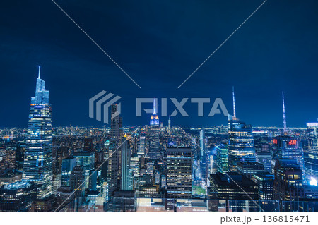 New York City skyline at night with illuminated Empire State Building and Midtown Manhattan skyscrapers 136815471