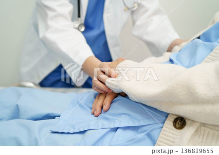 Asian doctor checking and treat elderly woman patient health in hospital. 136819655