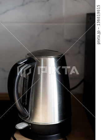 electric kettle on kitchen table electric kettle on kitchen table 136819815