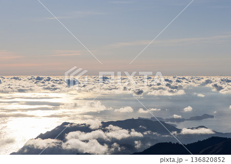 From Pico do Arieiro an Atlantic cloud sea opens as Sao Lourenco fades in haze and sunrise gleams From Pico do Arieiro an Atlantic cloud sea opens as Sao Lourenco fades in haze and sunrise gleams 136820852