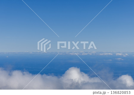 Low clouds hover over a blue sea horizon creating an airy minimal background Low clouds hover over a blue sea horizon creating an airy minimal background 136820853